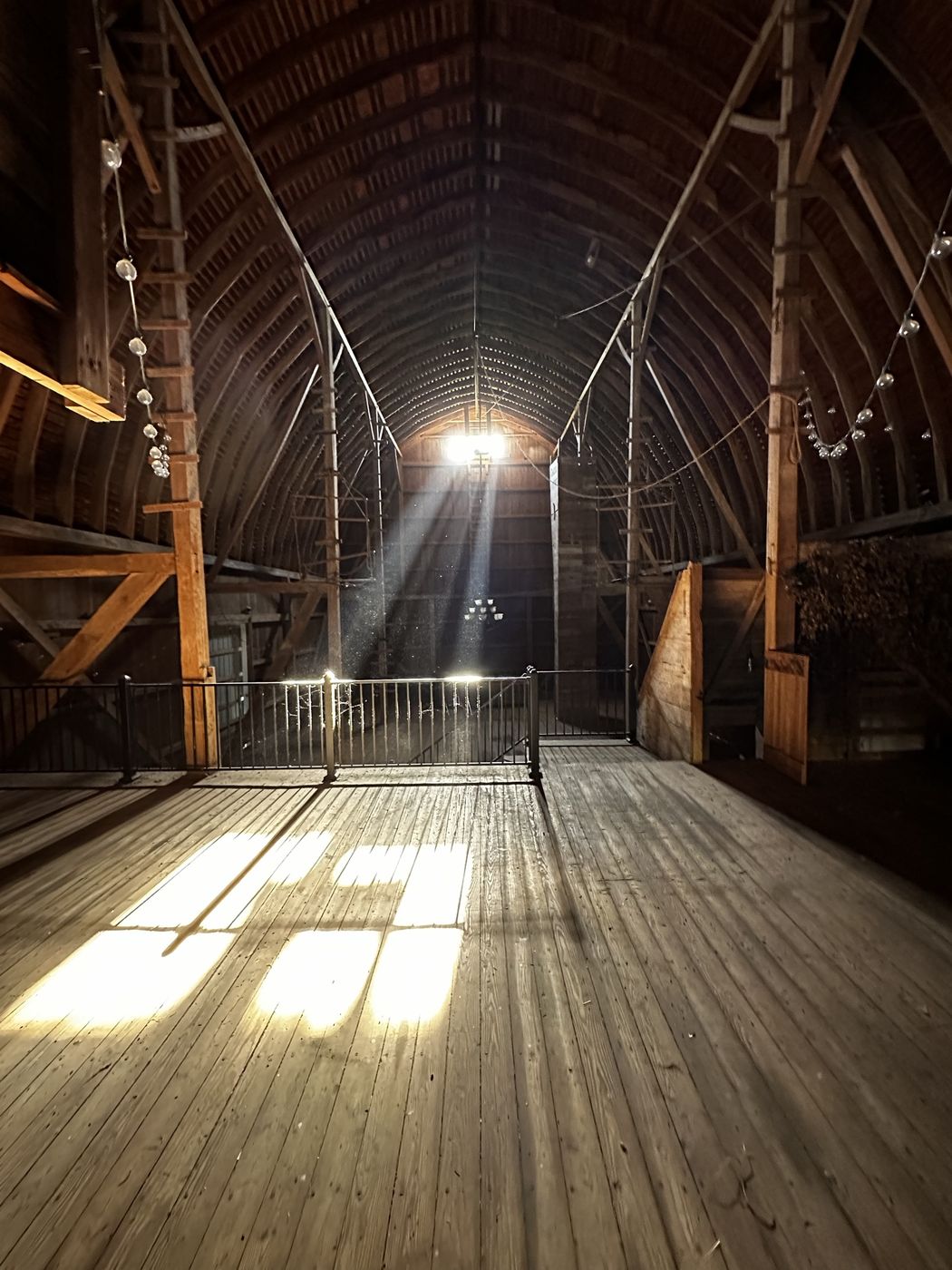 Sunlight streaming across the wooden floor of the barn hayloft